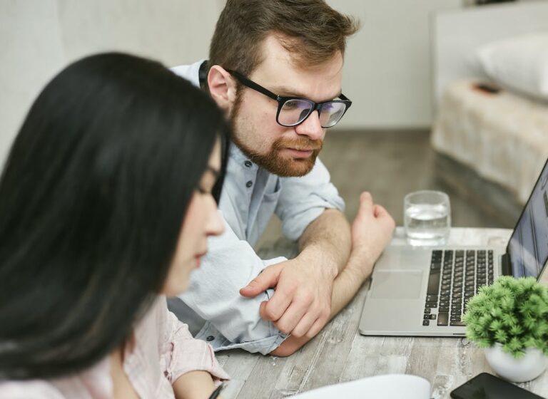 Photo of two people reviewing documents.